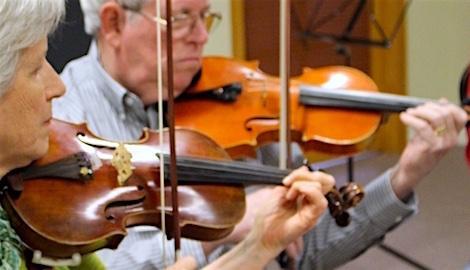 Adult string musicians rehearsing together